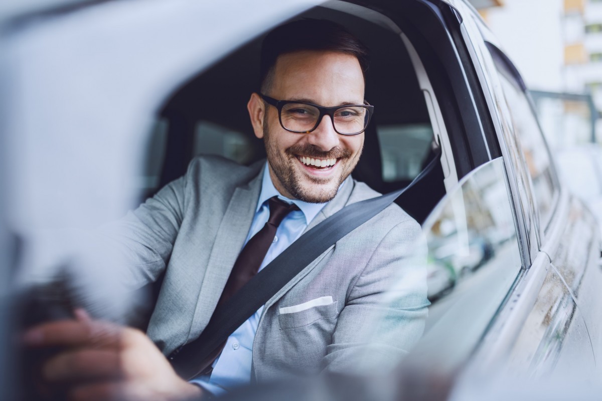 smiling driver behind the wheel