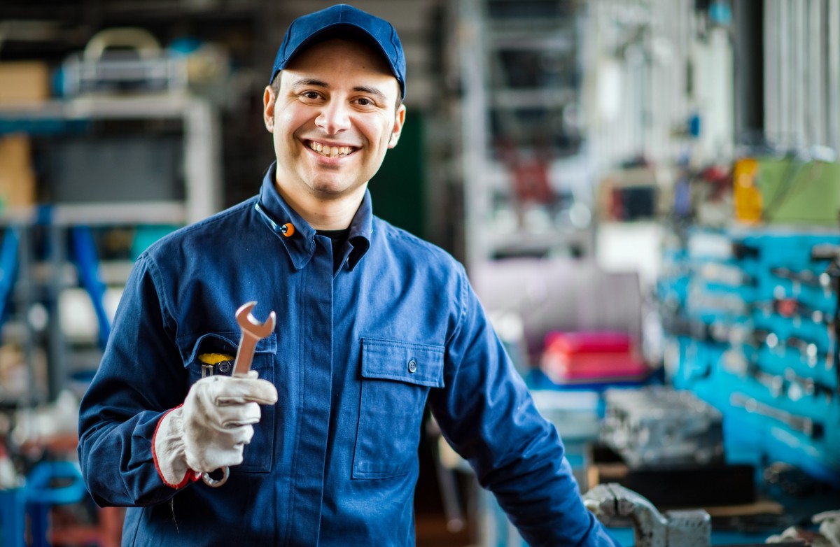 mechanic holding a wrench in auto shop